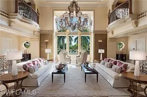 a living room with furniture and a chandelier