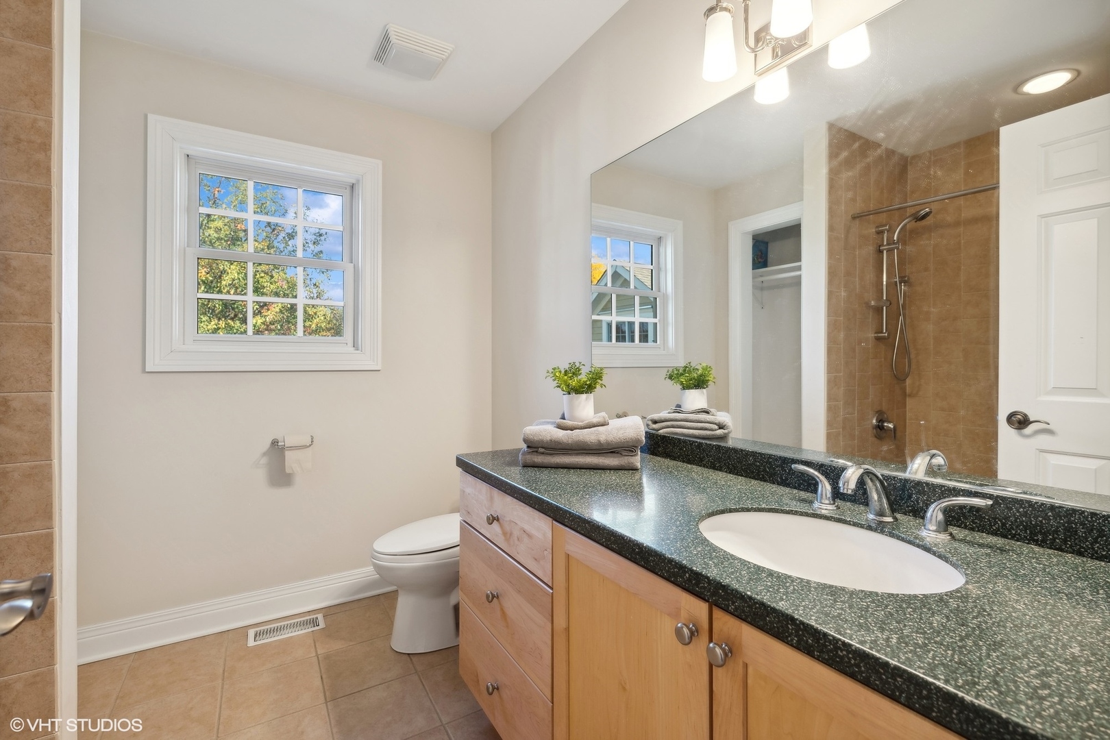 617 Hillside Road Glenview, IL 60025 - Photo 21 of 40 a bathroom with a granite countertop double vanity sink a mirror and a toilet