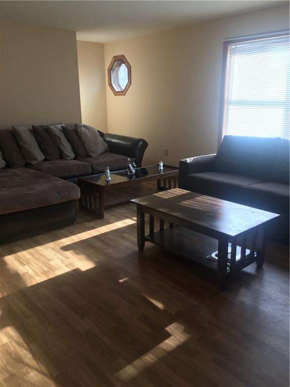 a living room with furniture a window and a table