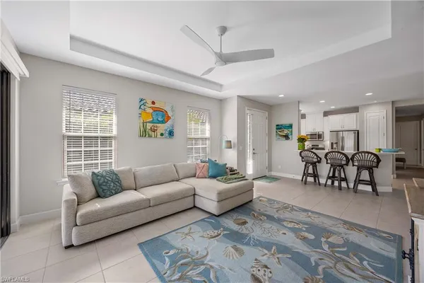 a living room with furniture and kitchen view