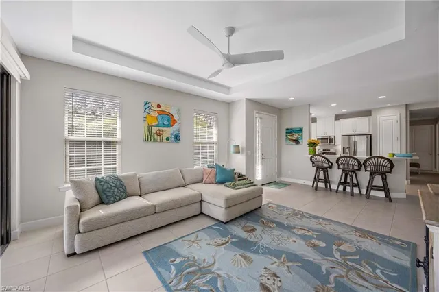 a living room with furniture and kitchen view