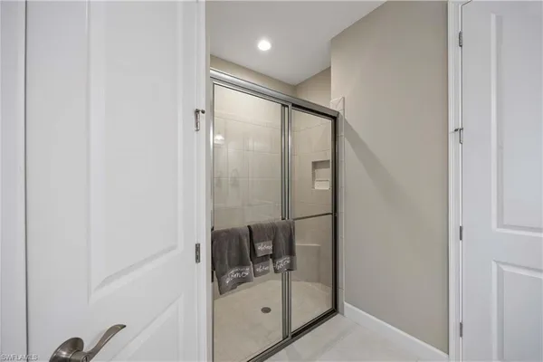 a bathroom with a glass shower door