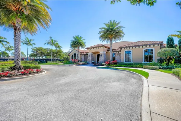 a front view of house with small garden and palm tree