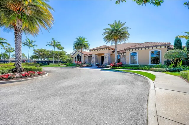 a front view of house with small garden and palm tree