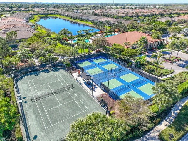 an aerial view of residential houses with outdoor space and swimming pool