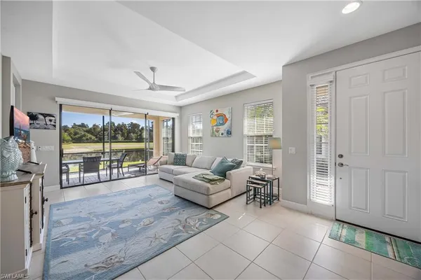 a living room with furniture and large windows