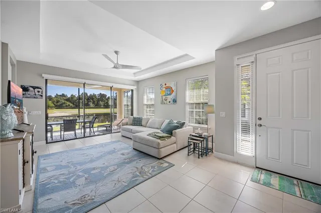 a living room with furniture and large windows