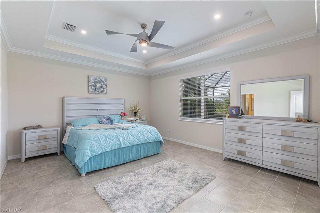 2079 Vermont Lane Naples, FL 34120 - Photo 11 of 12 a bedroom with a large bed and a window