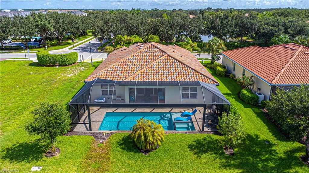 2079 Vermont Lane Naples, FL 34120 - Photo 3 of 12 a aerial view of a house with swimming pool and garden