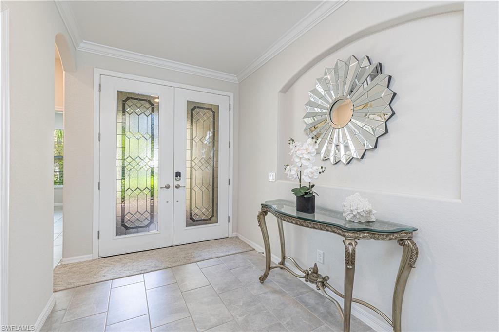 2079 Vermont Lane Naples, FL 34120 - Photo 5 of 12 a dining room with a wooden table and chairs