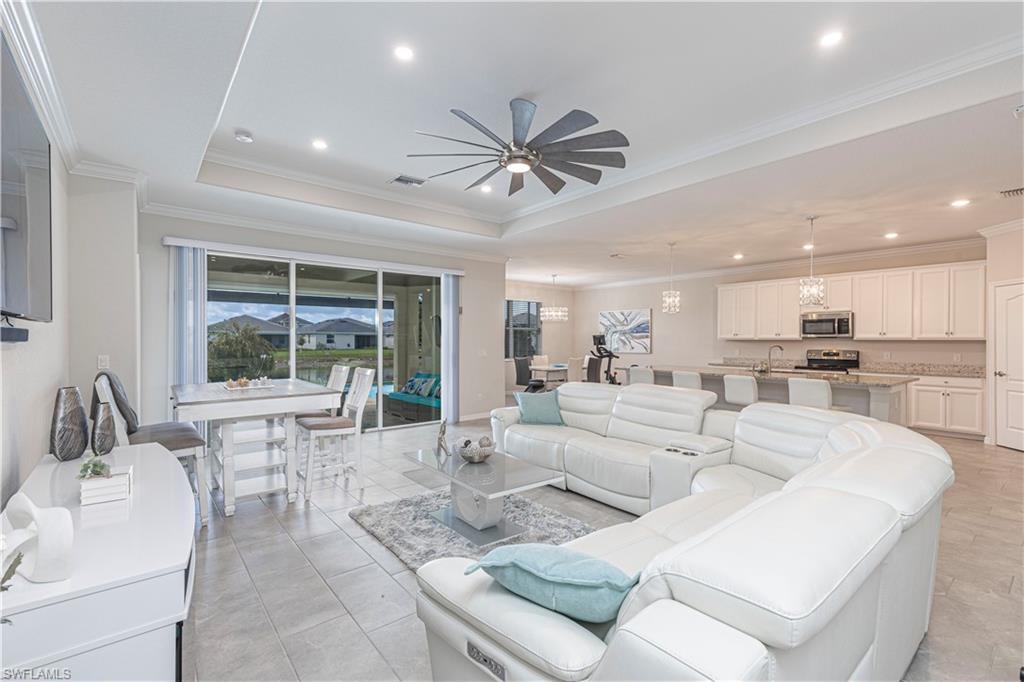 2079 Vermont Lane Naples, FL 34120 - Photo 8 of 12 a living room with furniture and a large window