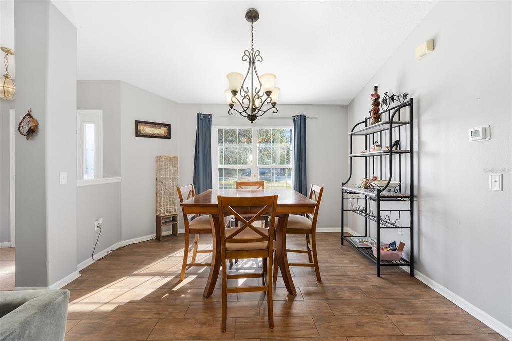 2219 Southwest 146th Loop Ocala, FL 34473 - Photo 11 of 32 a view of a dining room with furniture window and wooden floor