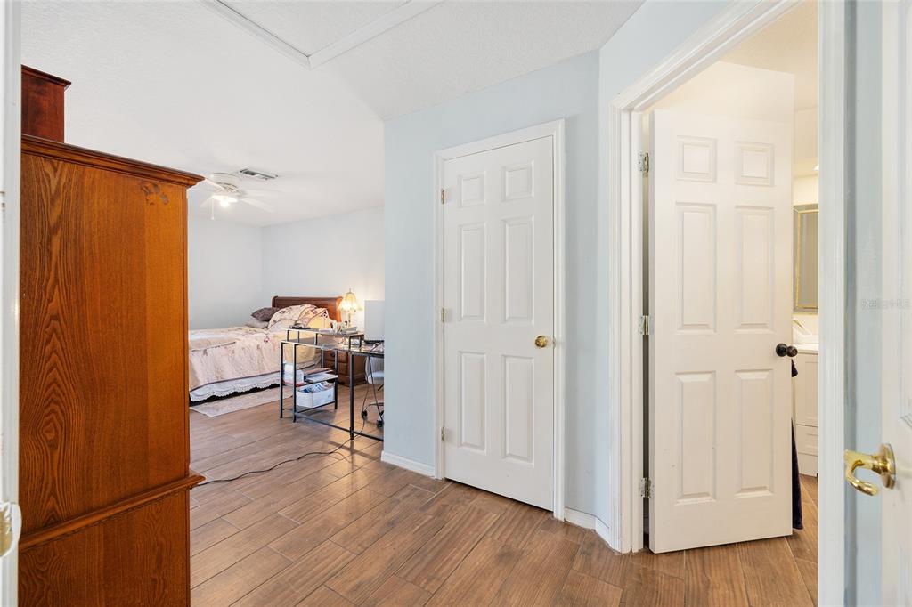 2219 Southwest 146th Loop Ocala, FL 34473 - Photo 20 of 32 a view of a hallway with wooden floor furniture and windows