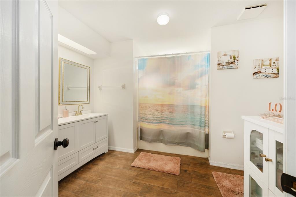 2219 Southwest 146th Loop Ocala, FL 34473 - Photo 21 of 32 a bathroom with a tub sink and mirror