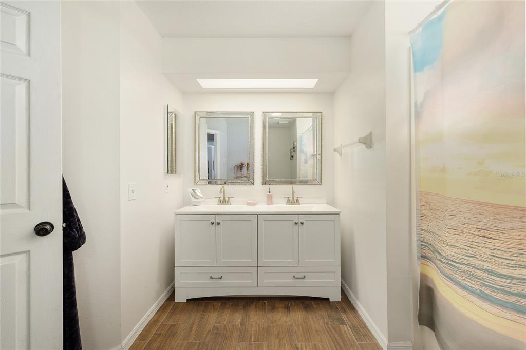 2219 Southwest 146th Loop Ocala, FL 34473 - Photo 22 of 32 a bathroom with a sink and a mirror