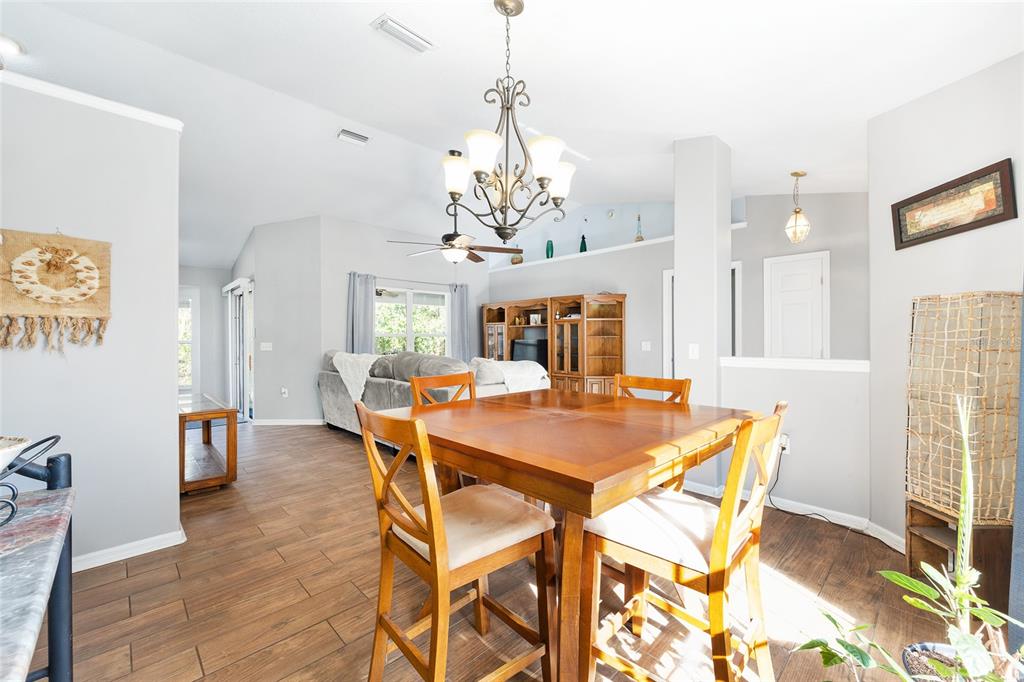 2219 Southwest 146th Loop Ocala, FL 34473 - Photo 9 of 32 a view of a dining room with furniture and window
