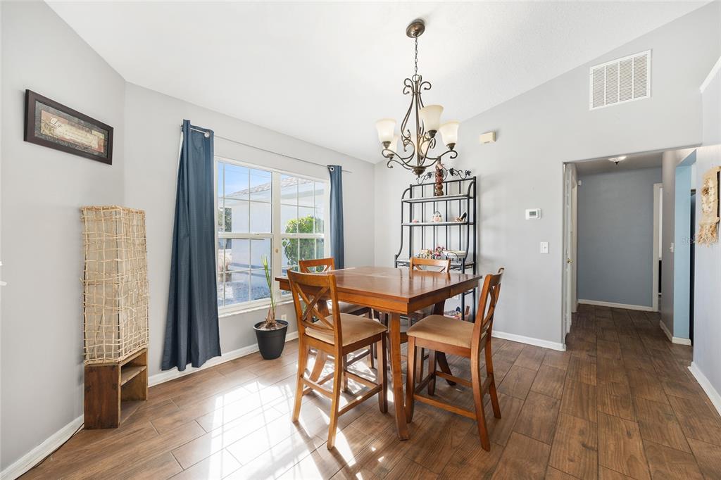 2219 Southwest 146th Loop Ocala, FL 34473 - Photo 10 of 32 a view of a dining room with furniture window and wooden floor