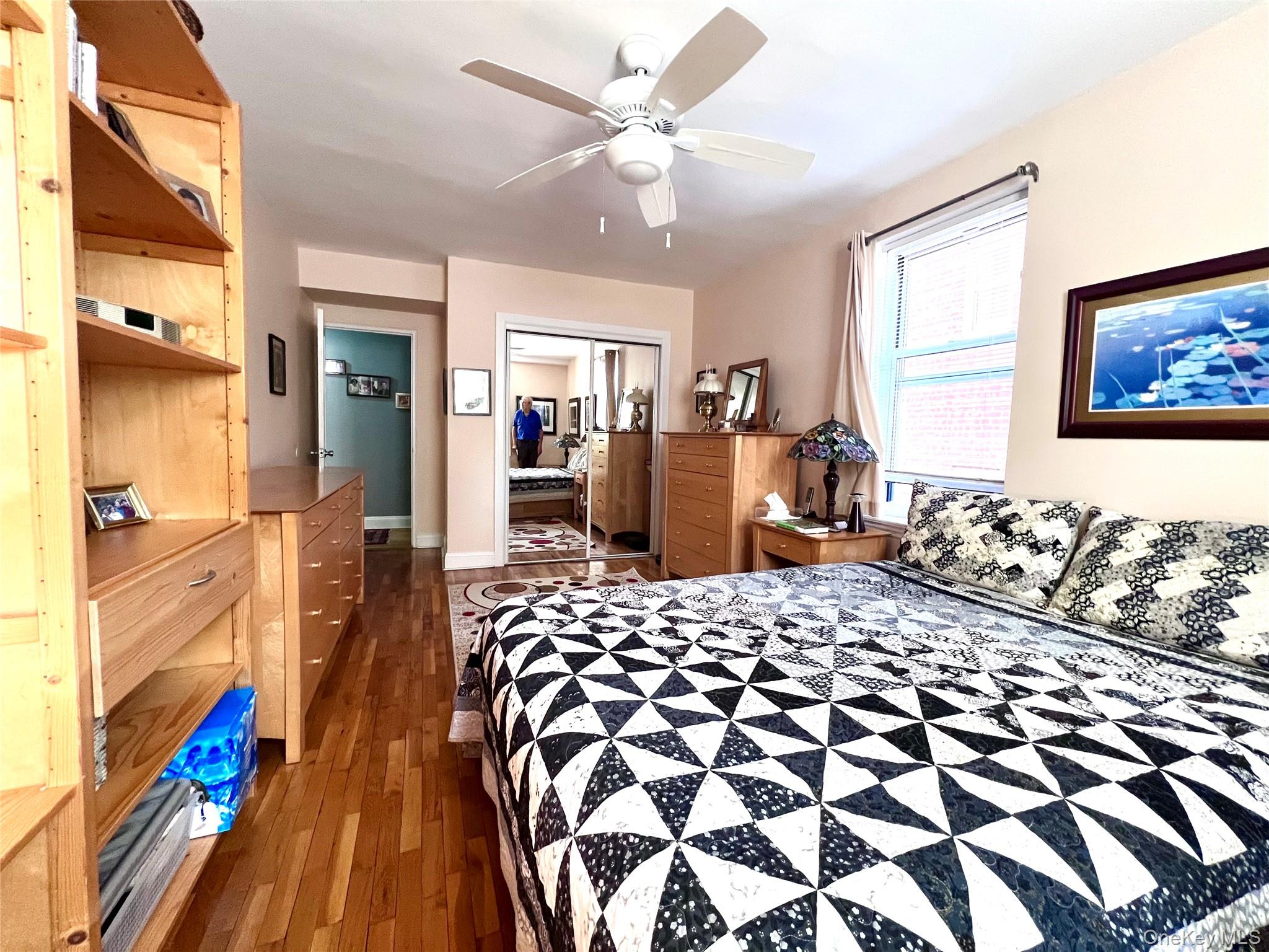2080 Barnes Avenue, Unit 5C Bronx, NY 10462 - Photo 12 of 13 a bedroom with a bed and wooden floor
