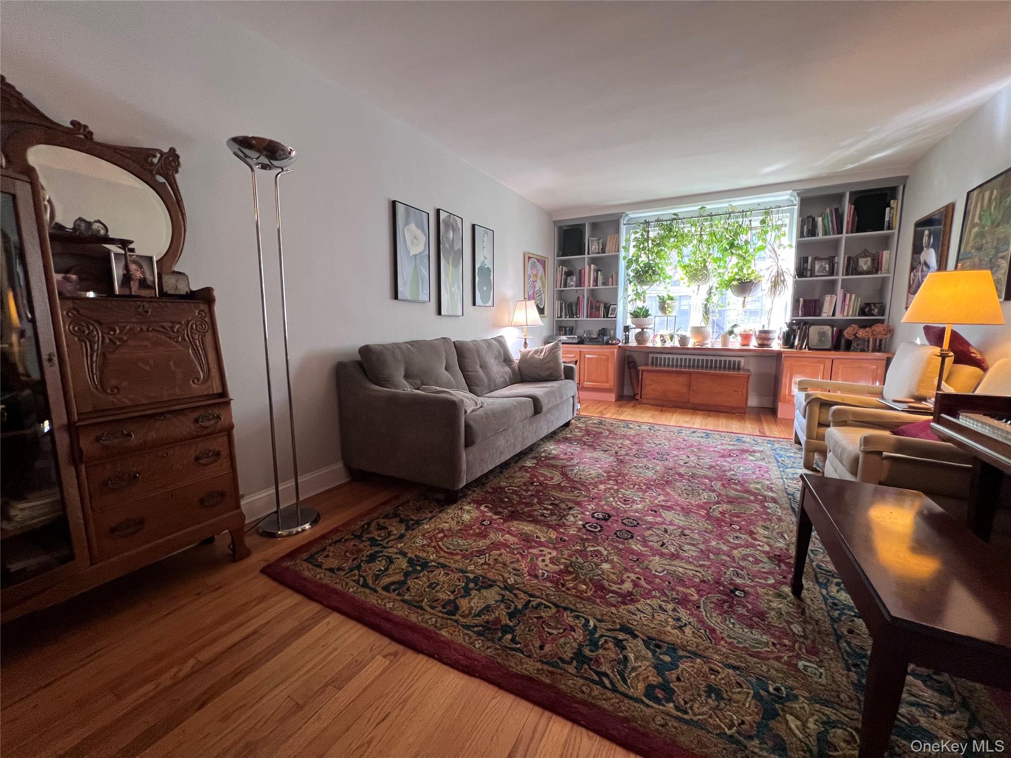 2080 Barnes Avenue, Unit 5C Bronx, NY 10462 - Photo 9 of 13 a living room with furniture and a window