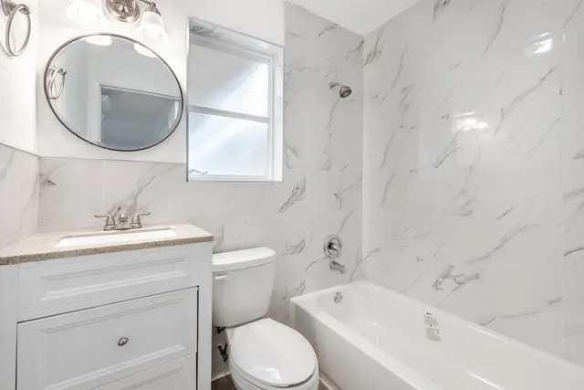 a bathroom with a sink a toilet and a mirror