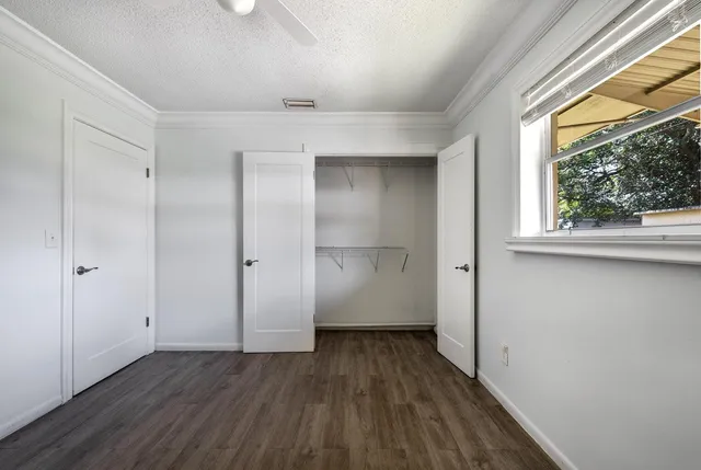 a view of a room with wooden floor and window