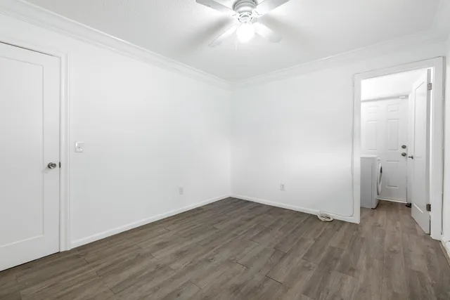 an empty room with wooden floor and closet