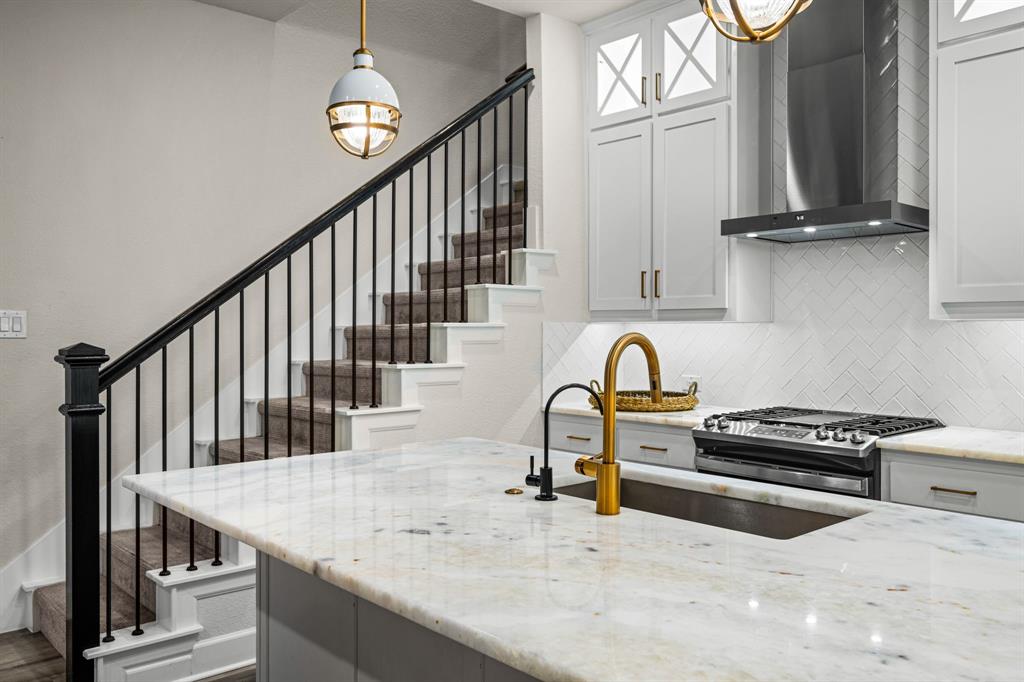 5325 Autumnbrook Court Dallas, TX 75209 - Photo 11 of 38 a kitchen with granite countertop a stove a sink and a cabinets