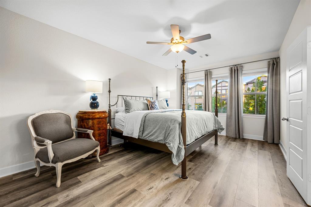 5325 Autumnbrook Court Dallas, TX 75209 - Photo 15 of 38 a bedroom with a bed a chair and a chandelier