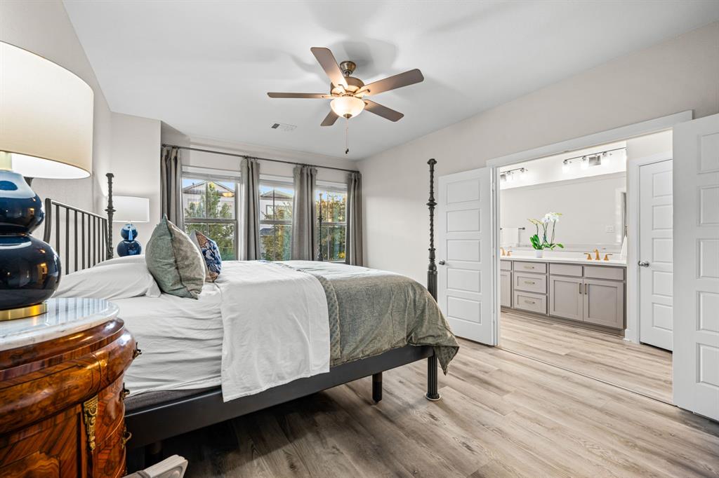 5325 Autumnbrook Court Dallas, TX 75209 - Photo 16 of 38 a bedroom with a bed a dresser and a large window