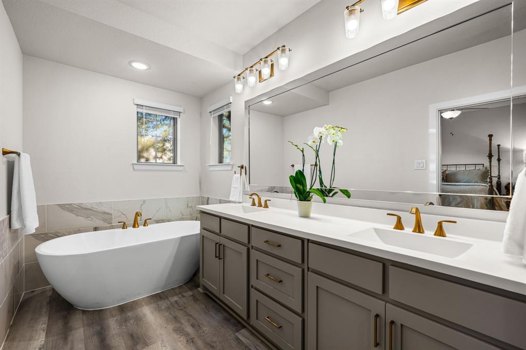 5325 Autumnbrook Court Dallas, TX 75209 - Photo 17 of 38 a spacious bathroom with a double vanity sink a mirror and a bathtub