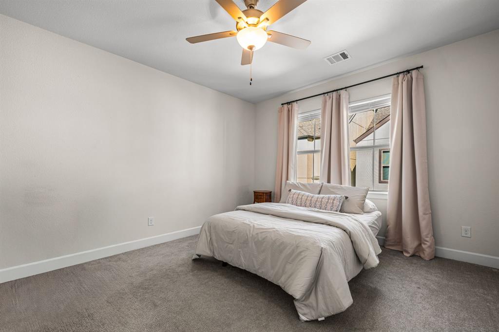 5325 Autumnbrook Court Dallas, TX 75209 - Photo 19 of 38 a bedroom with a bed and a chandelier