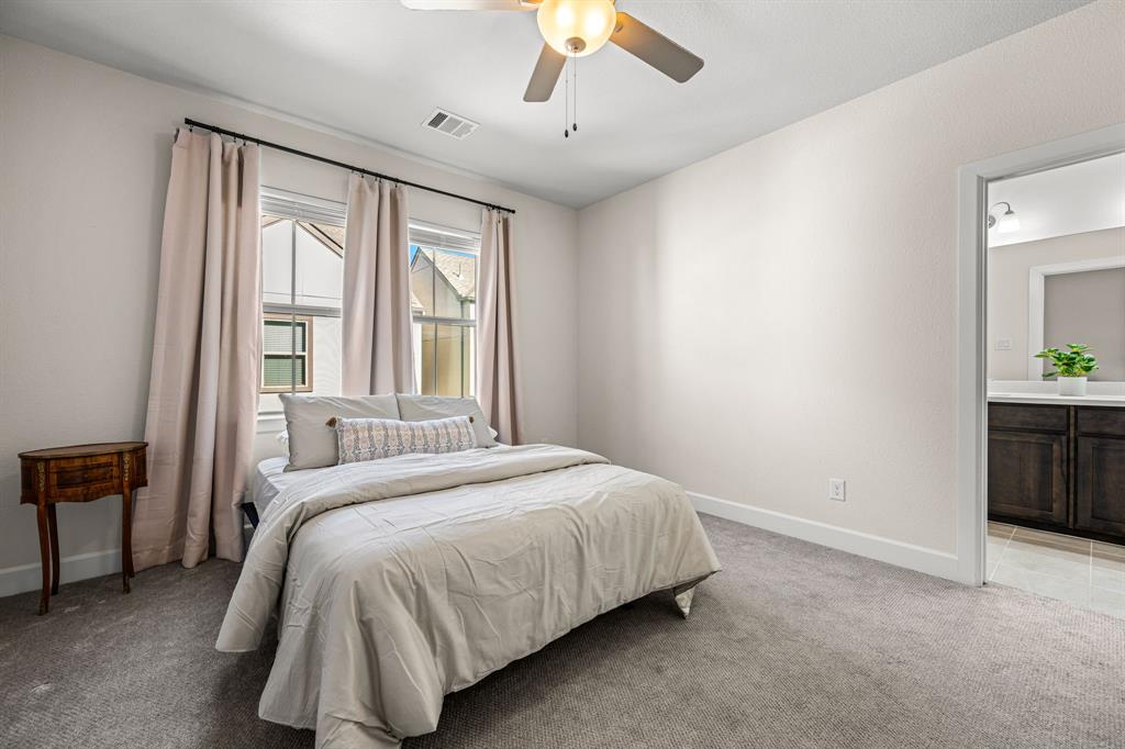 5325 Autumnbrook Court Dallas, TX 75209 - Photo 20 of 38 a bedroom with a bed and a chandelier