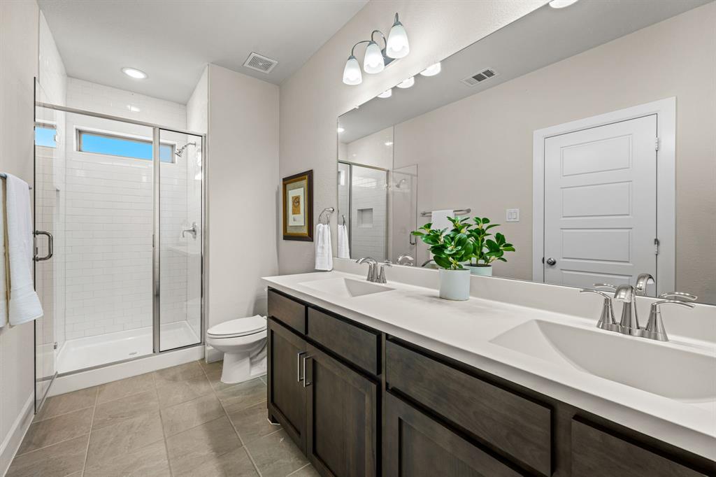 5325 Autumnbrook Court Dallas, TX 75209 - Photo 21 of 38 a bathroom with a sink a toilet and shower