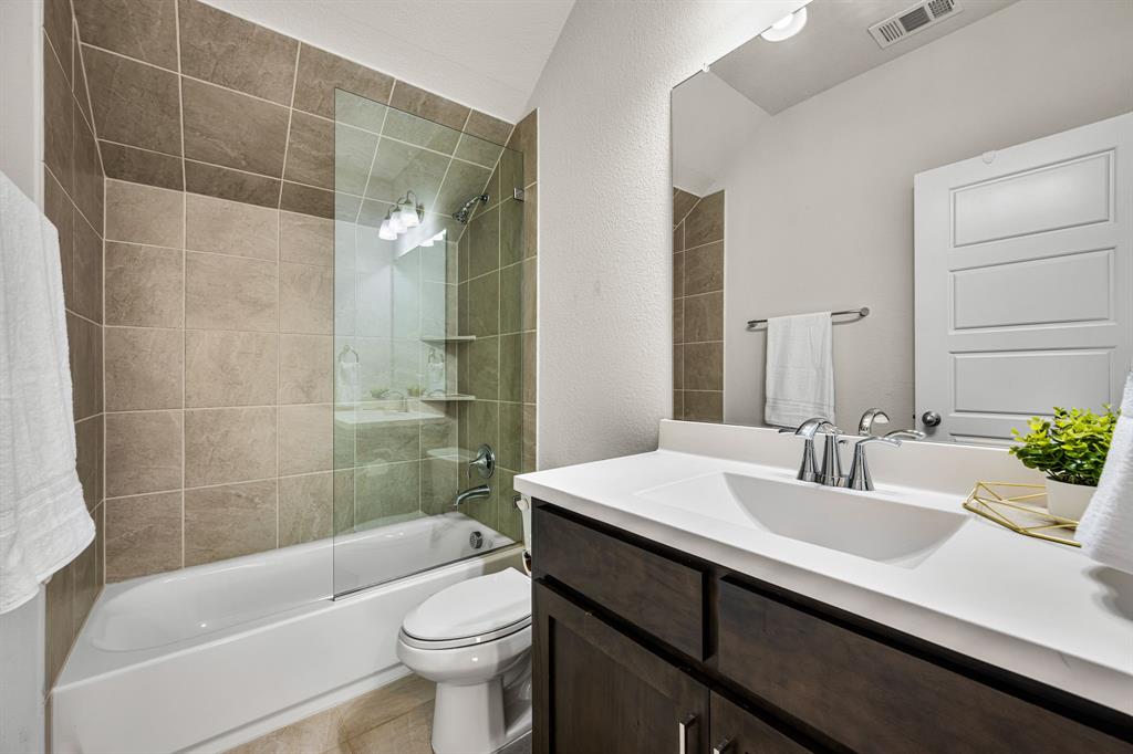 5325 Autumnbrook Court Dallas, TX 75209 - Photo 26 of 38 a bathroom with a sink a toilet and shower