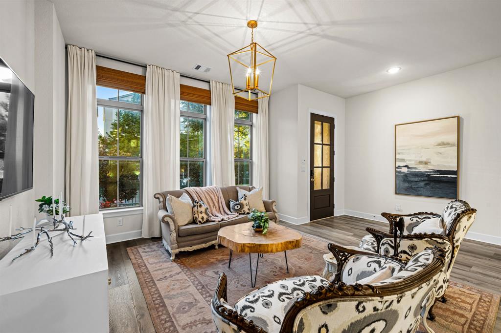 5325 Autumnbrook Court Dallas, TX 75209 - Photo 5 of 38 a living room with furniture a window and a chandelier