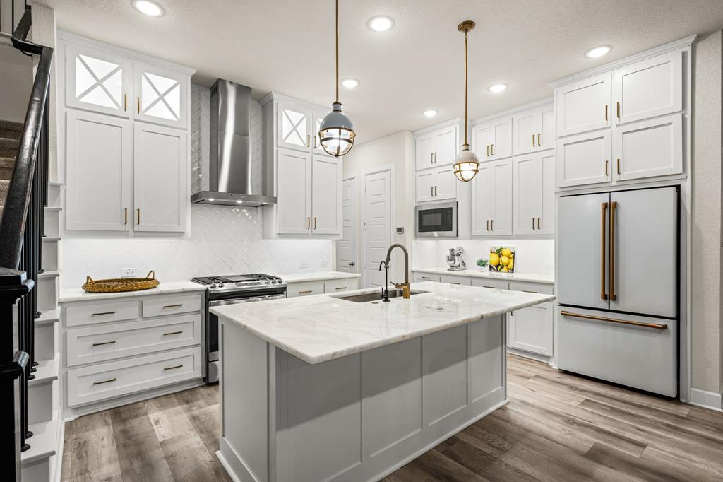 5325 Autumnbrook Court Dallas, TX 75209 - Photo 9 of 38 a kitchen with white cabinets and stainless steel appliances