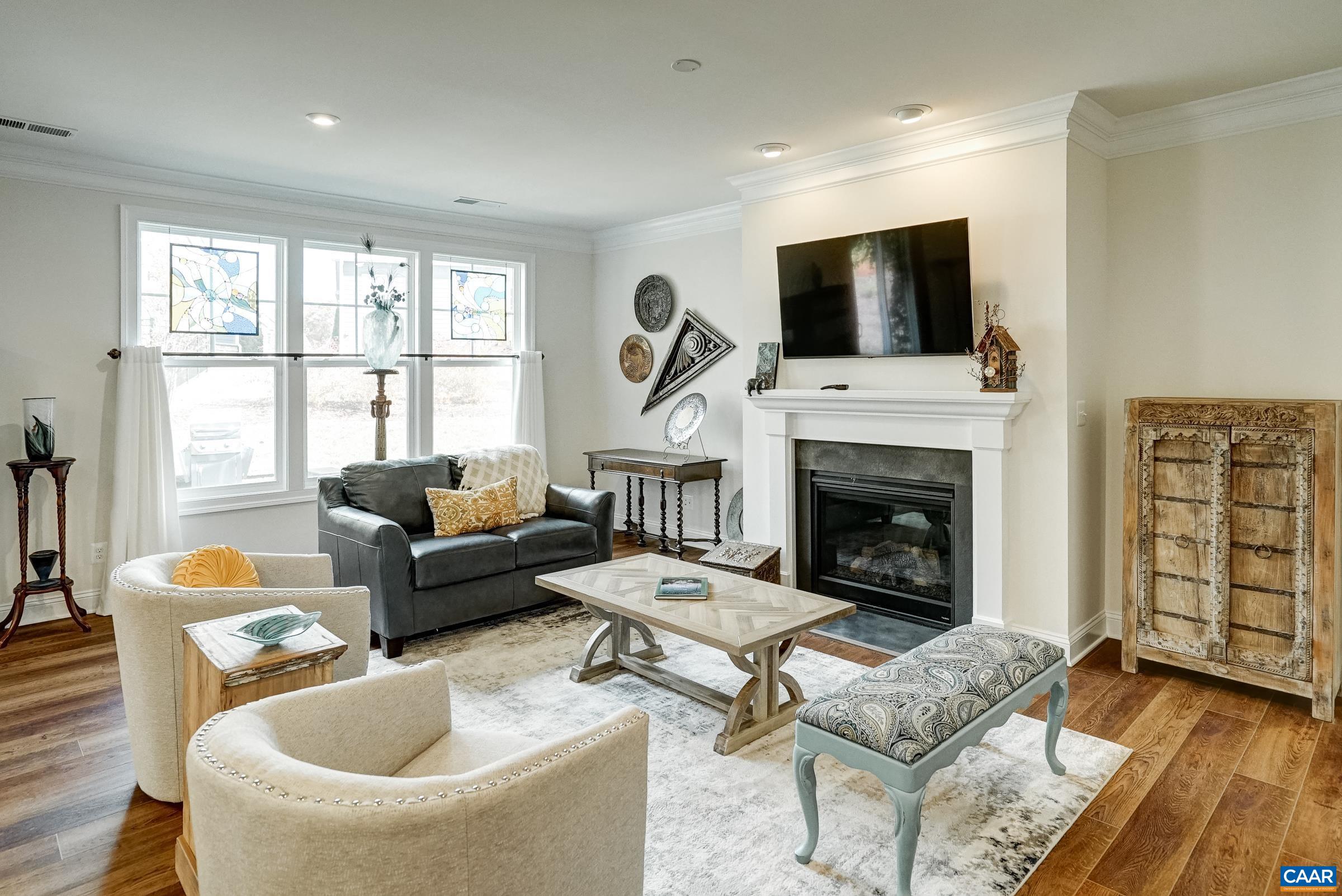 146 Timber Ridge Lane Zion Crossroads, VA 22942 - Photo 20 of 31 a living room with furniture a flat screen tv and a fireplace