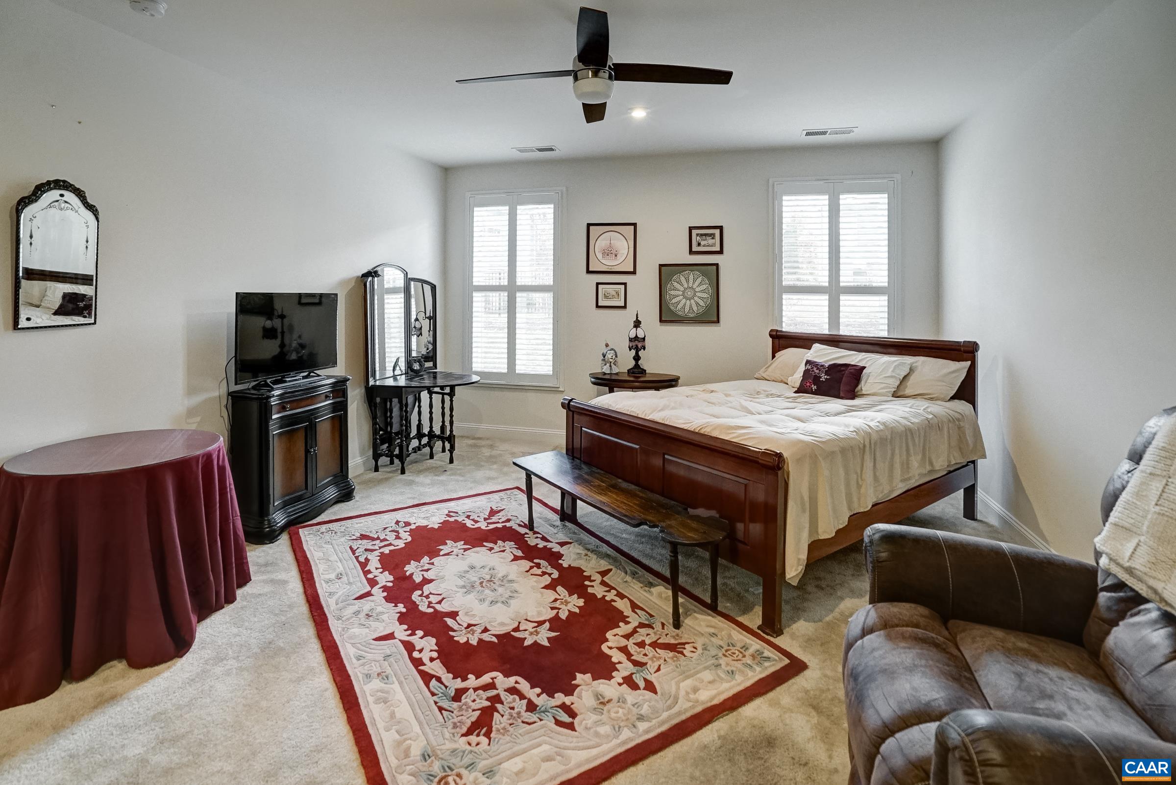 146 Timber Ridge Lane Zion Crossroads, VA 22942 - Photo 23 of 31 a living room with a bed furniture flat screen tv and a window