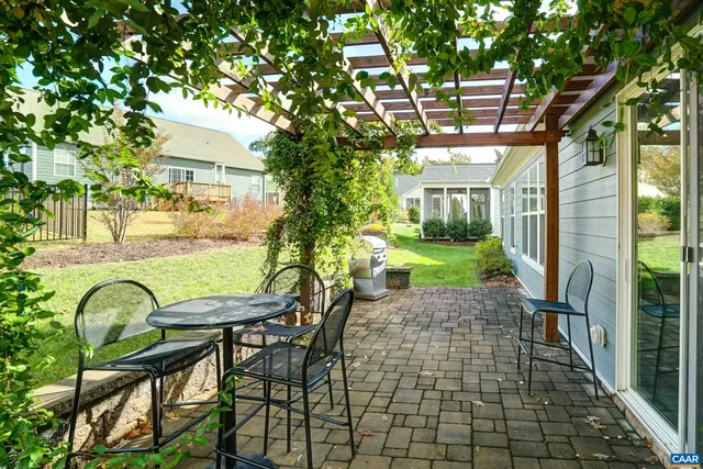 a view of a patio with table and chairs and potted plants