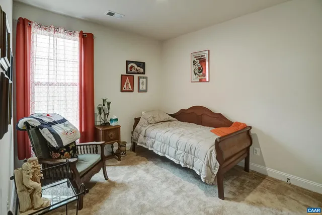 a bedroom with a bed and chair