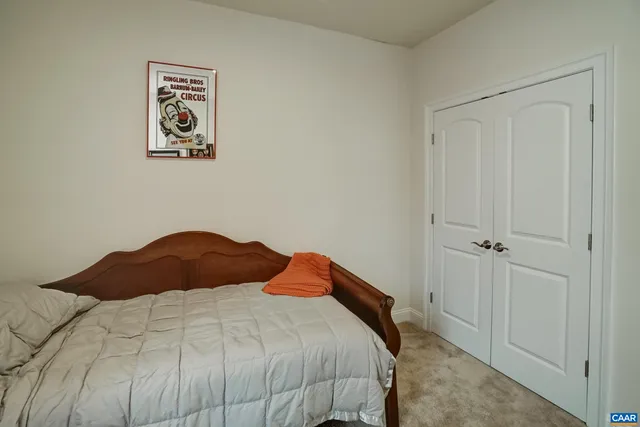 a bedroom with a bed and painting on the wall