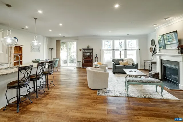 a living room with fireplace furniture and a wooden floor