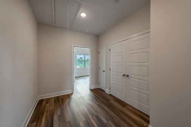 a view of hallway with wooden floor