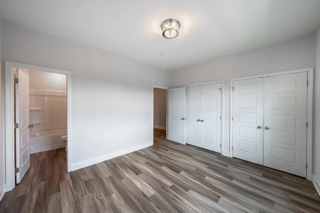 a view of a room with wooden floor