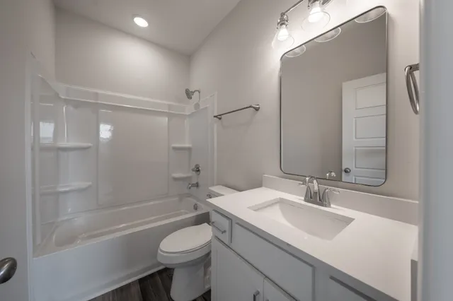 a bathroom with a sink toilet tub and shower