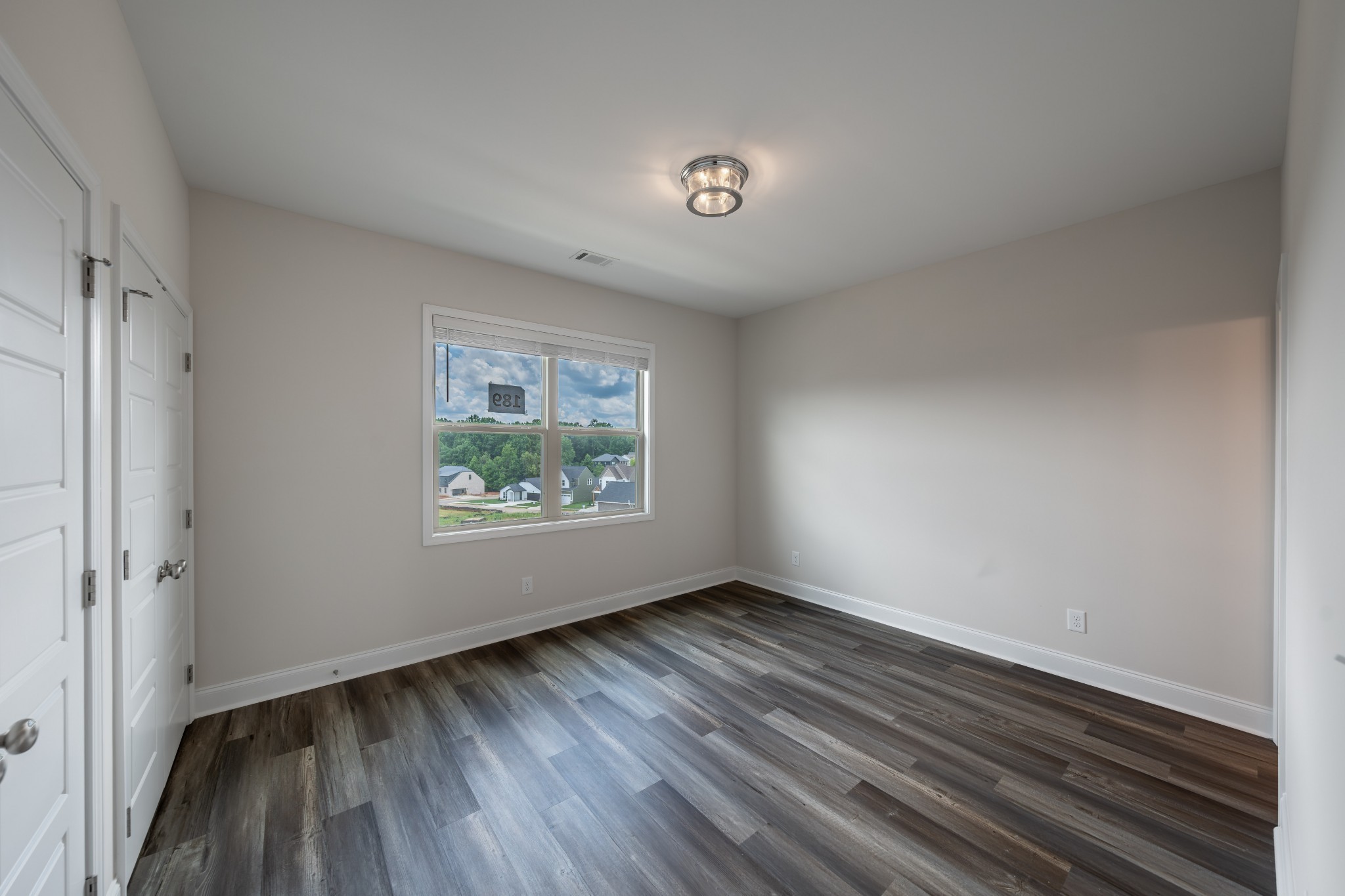 224 Franklin Street Pleasant View, TN 37146 - Photo 16 of 29 a view of an empty room with wooden floor and a window