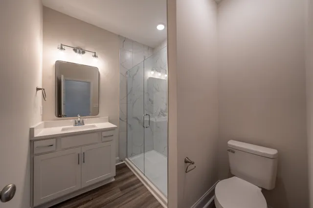 a bathroom with a toilet a sink and mirror