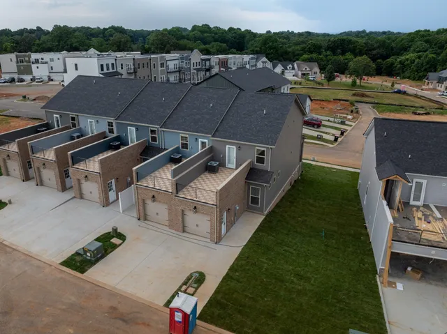 an aerial view of a house with garden space and street view