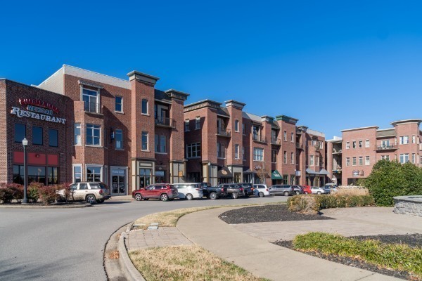 224 Franklin Street Pleasant View, TN 37146 - Photo 3 of 29 a city street lined with buildings and cars