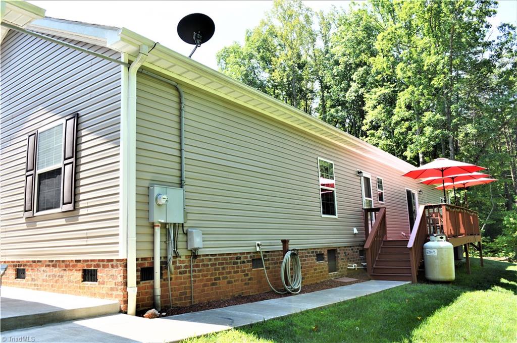 1387 Stewart Road Walnut Cove, NC 27052 - Photo 23 of 30 Rear view house with concrete sidewalk to back deck